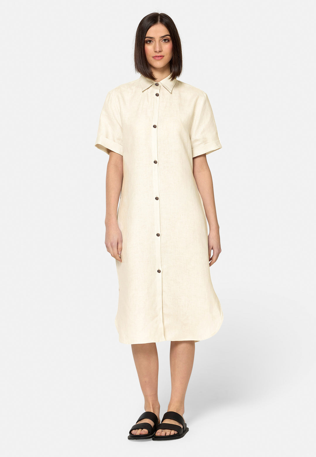 Bella, a relaxed Ecru shirt dress, offers effortless style with its button-down front, short T-shirt length sleeves, and curved hem. Crafted from breathable Baird McNuit Irish linen fabric, it’s perfect for warm-weather days. It combines comfort and versatility, making it a great choice for casual outings or laid-back weekends.