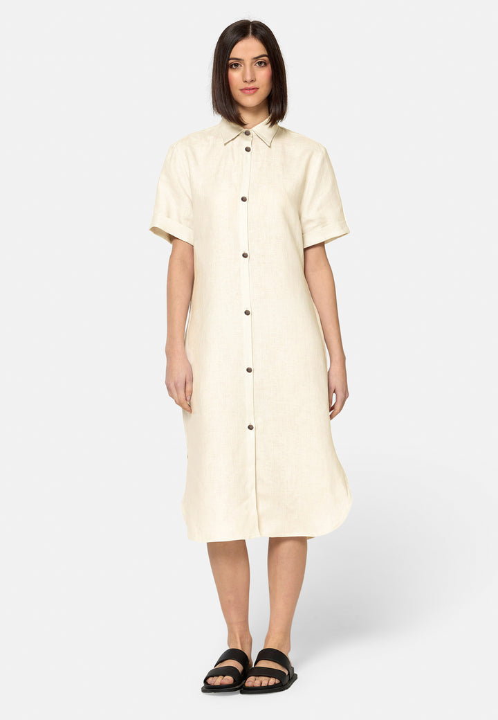 Bella, a relaxed Ecru shirt dress, offers effortless style with its button-down front, short T-shirt length sleeves, and curved hem. Crafted from breathable Baird McNuit Irish linen fabric, it’s perfect for warm-weather days. It combines comfort and versatility, making it a great choice for casual outings or laid-back weekends.