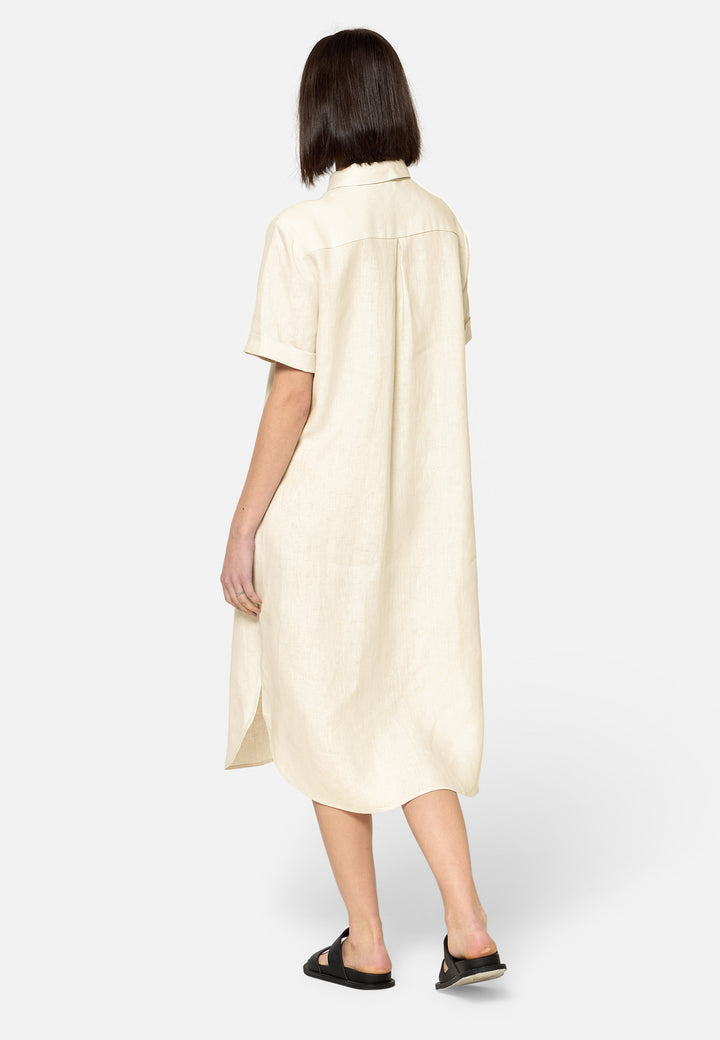 Bella, a relaxed Ecru shirt dress, offers effortless style with its button-down front, short T-shirt length sleeves, and curved hem. Crafted from breathable Baird McNuit Irish linen fabric, it’s perfect for warm-weather days. It combines comfort and versatility, making it a great choice for casual outings or laid-back weekends.