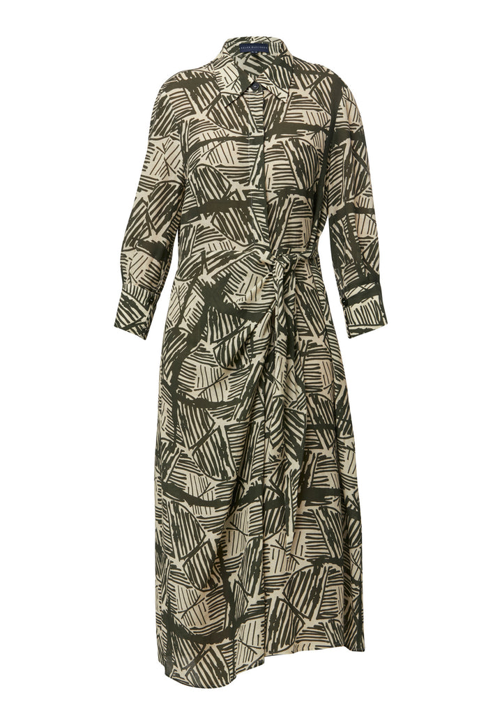 This Ashley Ogham Print Shirt Dress is a modern take on the classic shirt dress. Featuring a button-down front with a placket, full length sleeves with a button cuffed finish and simple shirt collar, it offers versatility and style. The wrap skirt ties off center to the front of the dress.