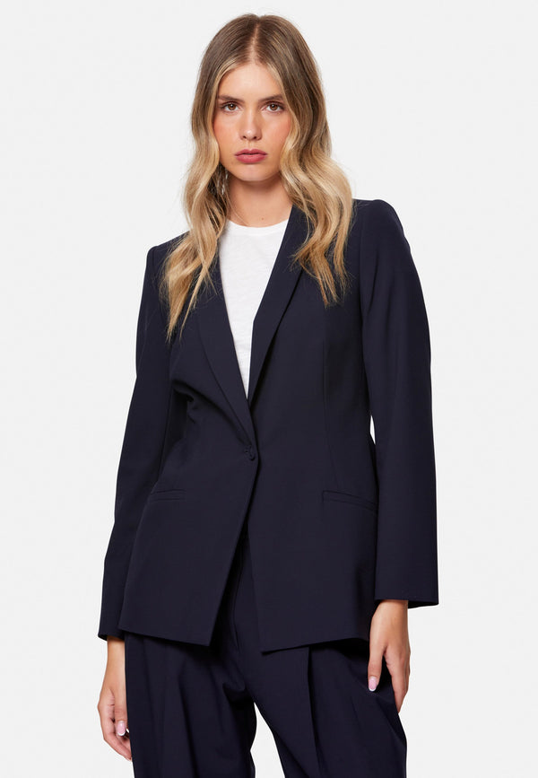 Darcie, the wear-everywhere blazer. Single-breasted with a tonal one-button fastening, tuxedo-inspired shawl collar and neat welt pockets. Cut to a longline, semi-fitted silhouette that flatters over dresses or trousers. Pair with the coordinating Lyra trousers for a modern suit, or throw on with denim at the weekend.