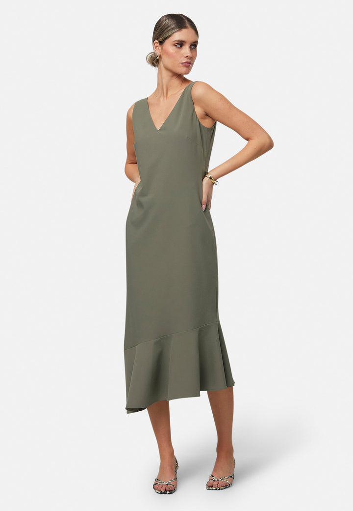 Dylan is a sleeveless midi dress featuring a clean, minimalist silhouette with a V-neckline and a soft, flared hemline for subtle movement. The back showcases an elegant bow detail that adds a touch of visual interest. Made from a smooth, lightweight fabric cut on its bias, the dress ensures comfort and versatility for both casual and formal occasions. Pair it with heels or flats for effortless styling.
