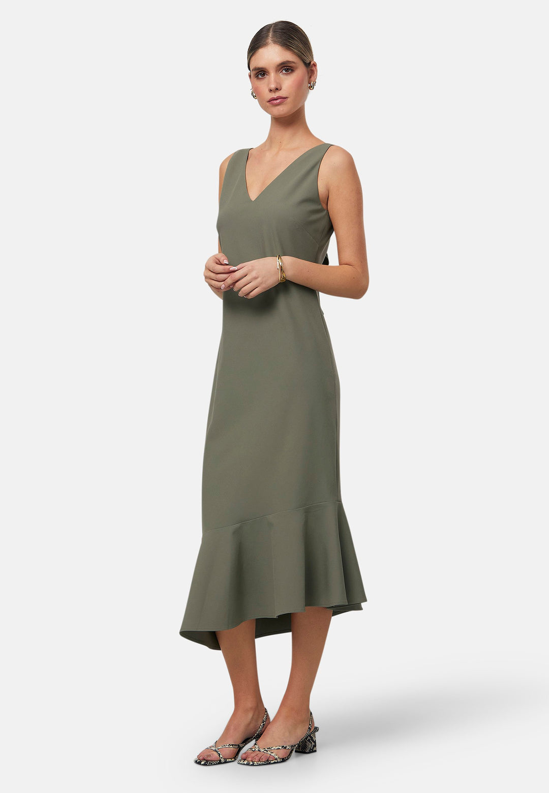 Dylan is a sleeveless midi dress featuring a clean, minimalist silhouette with a V-neckline and a soft, flared hemline for subtle movement. The back showcases an elegant bow detail that adds a touch of visual interest. Made from a smooth, lightweight fabric cut on its bias, the dress ensures comfort and versatility for both casual and formal occasions. Pair it with heels or flats for effortless styling.