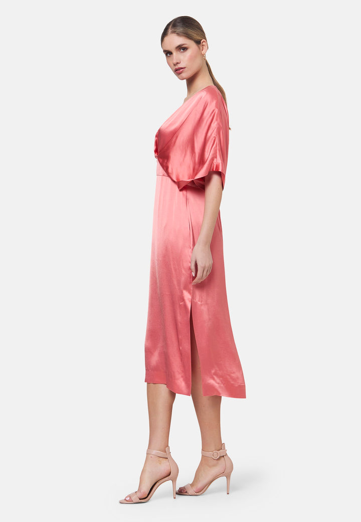 Eabha, the coral rose dress with quiet glamour. Cut from fluid, silk-touch satin, it frames the neckline with a gentle V and draped kimono sleeves, then gathers into under-bust pleats that flatter the waistline. The column midi skirt skims beautifully with discreet side seam pockets and slits for ease, finished with a neat keyhole back. Just add barely-there heels and gold jewellery.