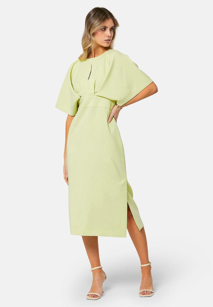 A radiant piece designed to elevate your warm-weather wardrobe. Drenched in a vibrant lime hue, this dress effortlessly captures the essence of summer elegance. The relaxed silhouette drapes gracefully to a flattering mid-calf length, ensuring both comfort and style on sun-filled days. Highlighted by pronounced pleats at the center front bodice and a subtle front slit, it infuses a touch of allure into its design.