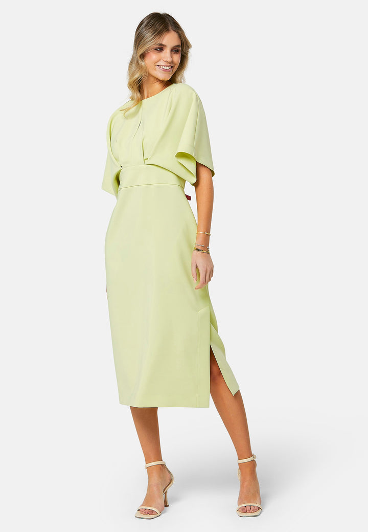 A radiant piece designed to elevate your warm-weather wardrobe. Drenched in a vibrant lime hue, this dress effortlessly captures the essence of summer elegance. The relaxed silhouette drapes gracefully to a flattering mid-calf length, ensuring both comfort and style on sun-filled days. Highlighted by pronounced pleats at the center front bodice and a subtle front slit, it infuses a touch of allure into its design.