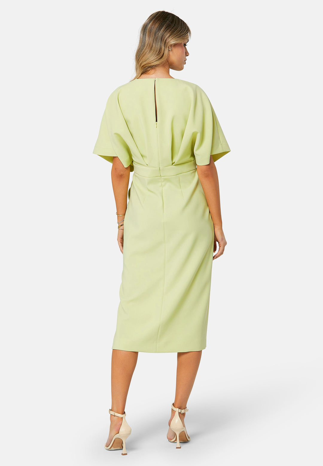 A radiant piece designed to elevate your warm-weather wardrobe. Drenched in a vibrant lime hue, this dress effortlessly captures the essence of summer elegance. The relaxed silhouette drapes gracefully to a flattering mid-calf length, ensuring both comfort and style on sun-filled days. Highlighted by pronounced pleats at the center front bodice and a subtle front slit, it infuses a touch of allure into its design.