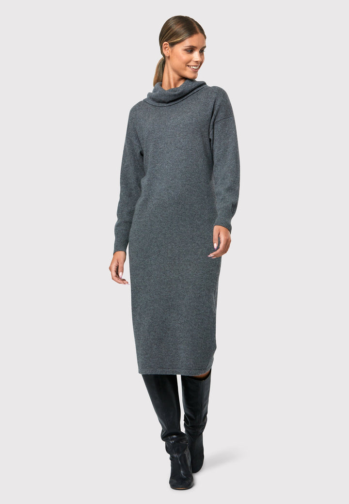 Have you met the Elora Charcoal Grey Cashmere Dress? A chic and versatile addition to your wardrobe. This midi-length dress features a loose, drapey polo neck, exuding effortless elegance. With full-length sleeves and tight ribbed cuffs, it offers a stylish yet comfortable fit. Crafted from luxurious cashmere, this dress effortlessly combines sophistication and comfort, making it the perfect go-to piece for any occasion.