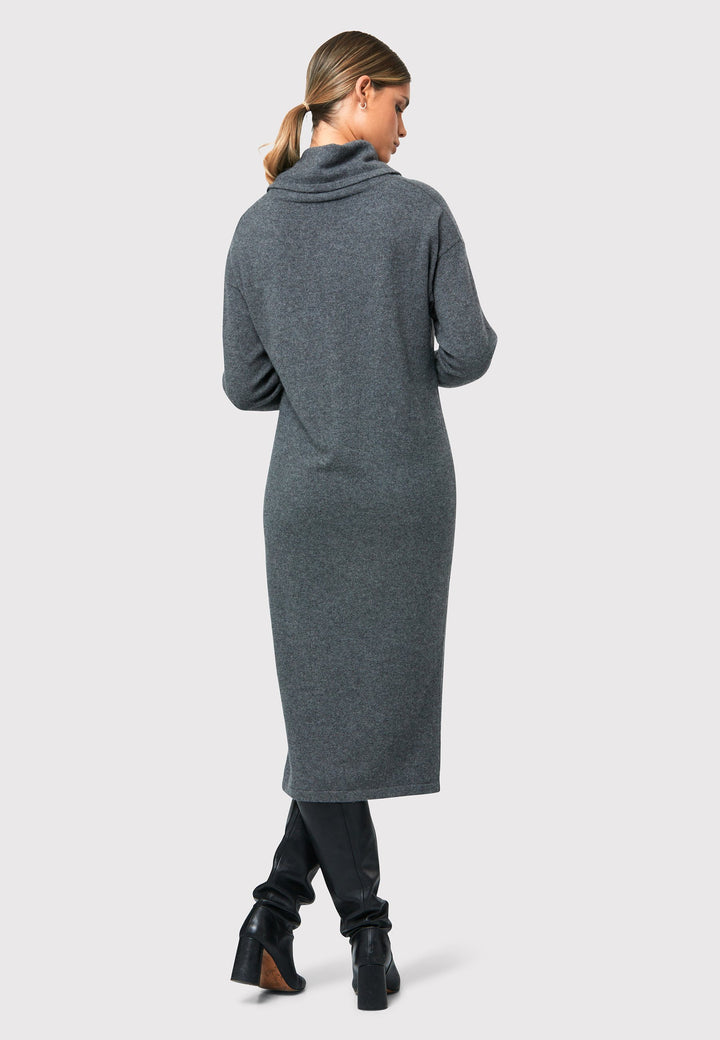 Have you met the Elora Charcoal Grey Cashmere Dress? A chic and versatile addition to your wardrobe. This midi-length dress features a loose, drapey polo neck, exuding effortless elegance. With full-length sleeves and tight ribbed cuffs, it offers a stylish yet comfortable fit. Crafted from luxurious cashmere, this dress effortlessly combines sophistication and comfort, making it the perfect go-to piece for any occasion.