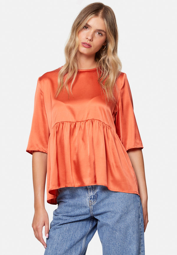 Woman wearing silk orange blouse