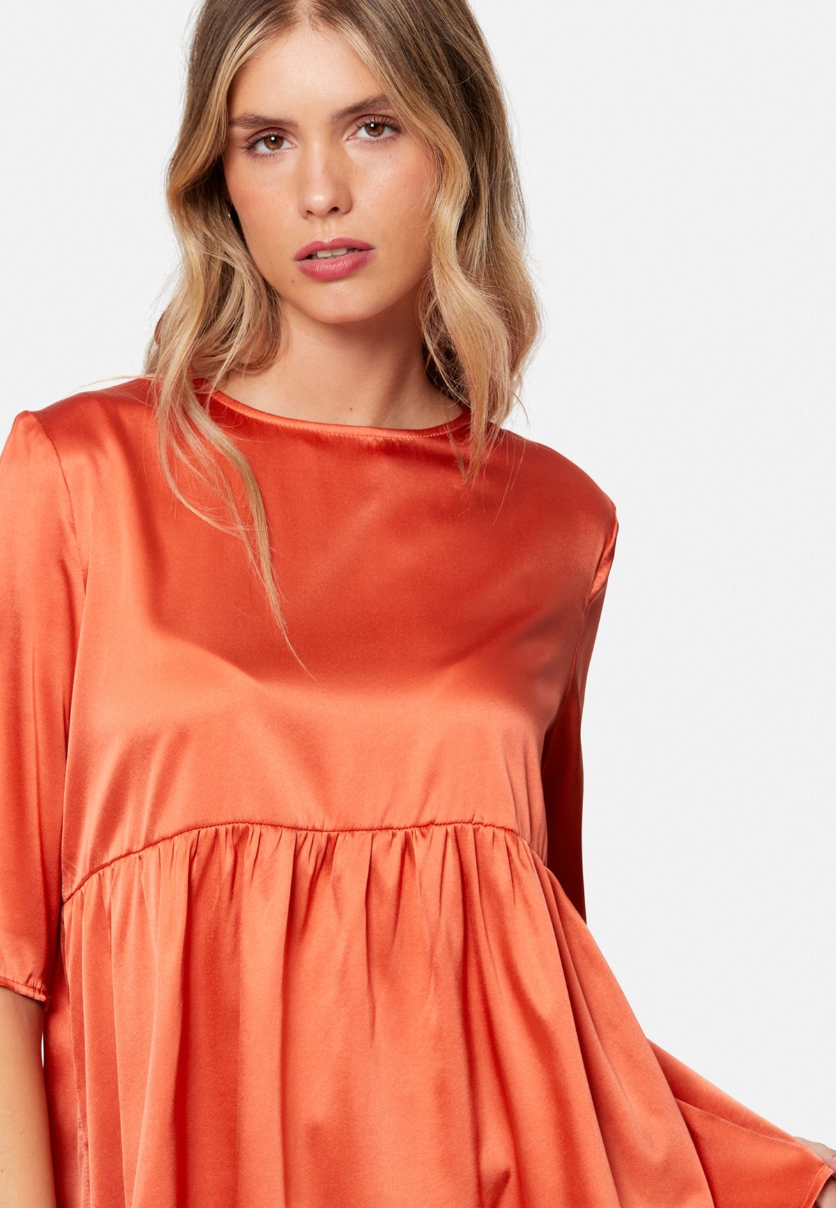 Woman wearing silk orange blouse