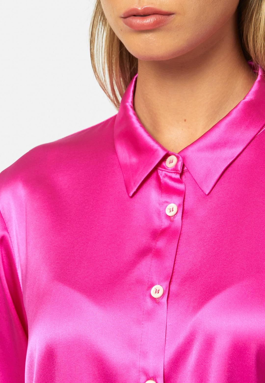 Women wearing a pink fuchsia silk satin shirt