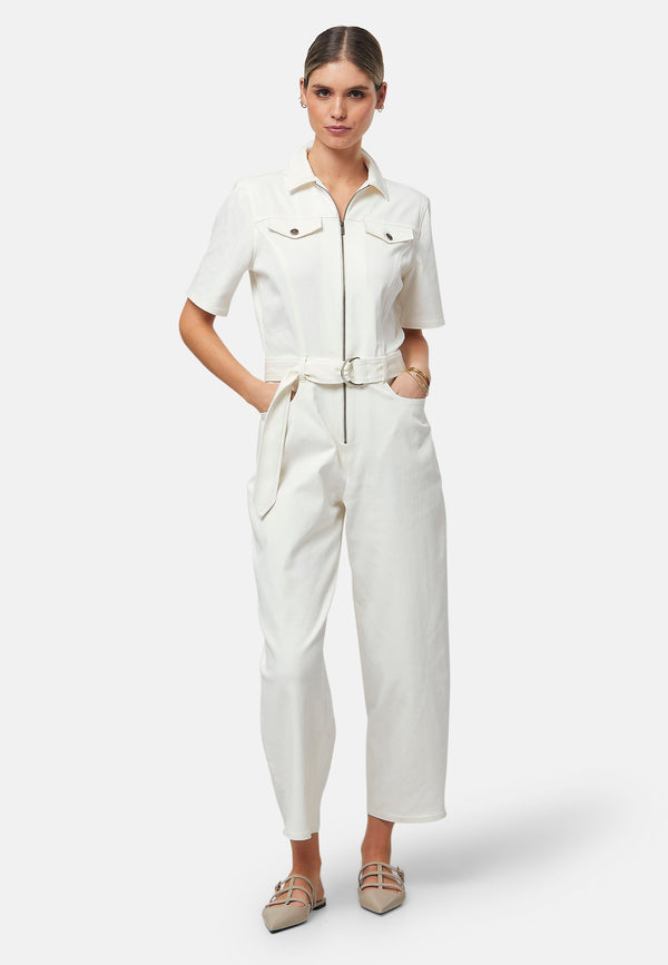 Step into utilitarian chic with this Ivory Jumpsuit. Featuring a zip-front closure, t-shirt sleeves, and a belted waist for a flattering fit, it’s your perfect blend of style and functionality. Whether you're running errands or heading out, this look says "effortless cool" with minimal effort.