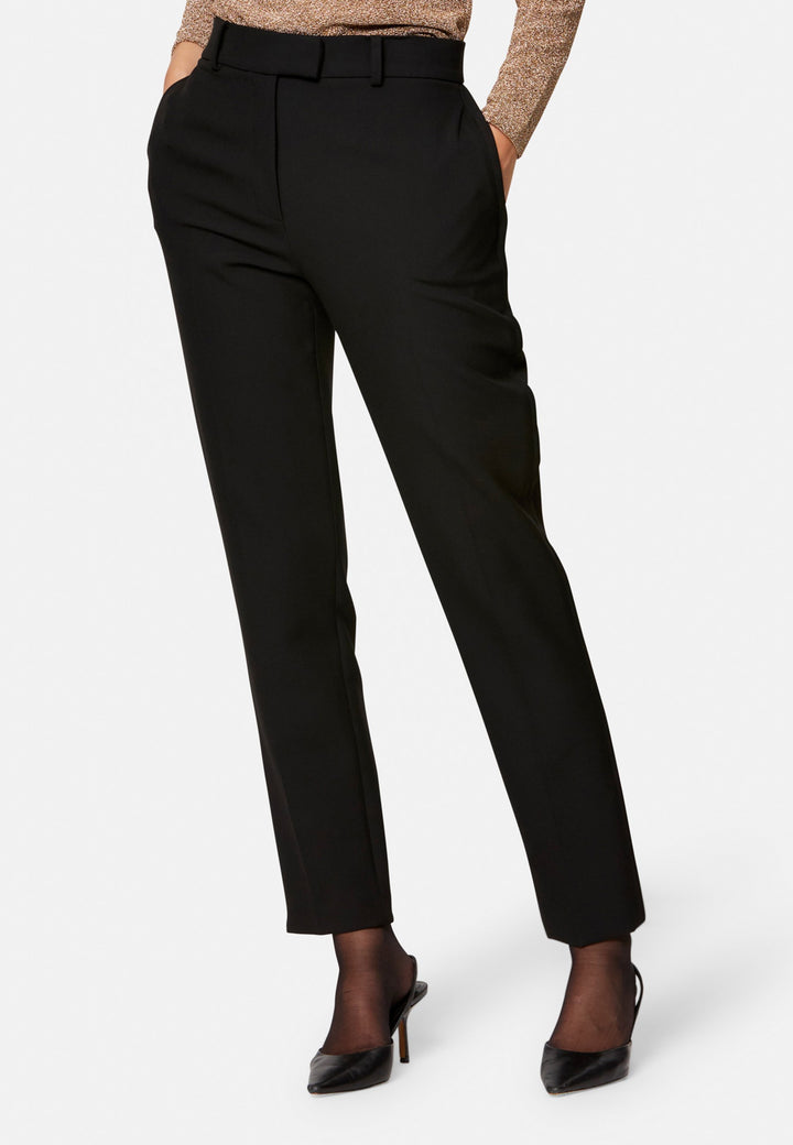 Cut from our signature tricotine with a hint of stretch, they sit neatly at the waist with a clean waistband, belt loops and concealed fastening. Pressed creases sharpen the narrow leg to an ankle-skimming finish, while side pockets keep them practical. Pair with the coordinating silk shirt for polish, or a crisp white tee for ease.