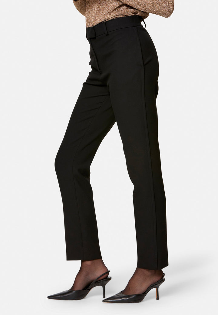 Cut from our signature tricotine with a hint of stretch, they sit neatly at the waist with a clean waistband, belt loops and concealed fastening. Pressed creases sharpen the narrow leg to an ankle-skimming finish, while side pockets keep them practical. Pair with the coordinating silk shirt for polish, or a crisp white tee for ease.