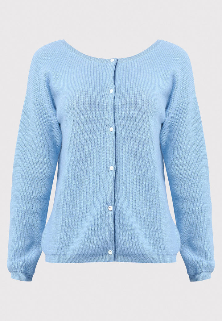 The Greta Cashmere Cardigan in Porcelain Blue brings a touch of elegance and versatility to your wardrobe. Designed with ribbed detailing and a neat finish, this reversible cardigan can be worn as a button-back jumper for a modern twist or layered over the Marlena Cashmere Sweater-Vest for a seamless look. Made from luxurious cashmere, it provides exceptional comfort and sophistication, making it an essential piece for any stylish collection.