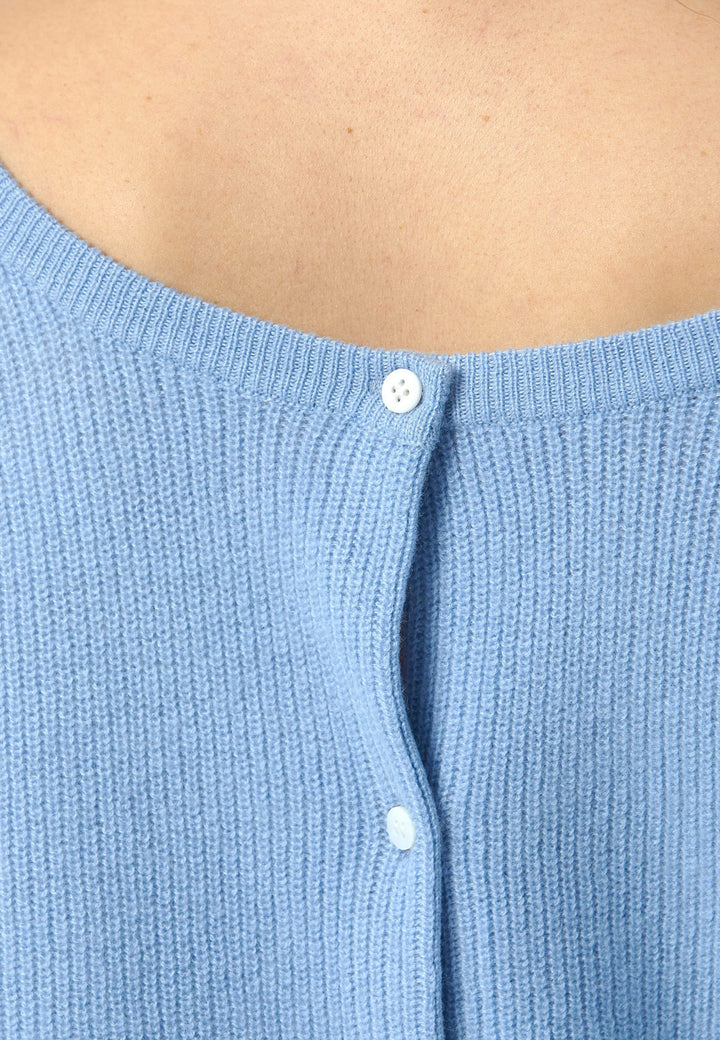 The Greta Cashmere Cardigan in Porcelain Blue brings a touch of elegance and versatility to your wardrobe. Designed with ribbed detailing and a neat finish, this reversible cardigan can be worn as a button-back jumper for a modern twist or layered over the Marlena Cashmere Sweater-Vest for a seamless look. Made from luxurious cashmere, it provides exceptional comfort and sophistication, making it an essential piece for any stylish collection.