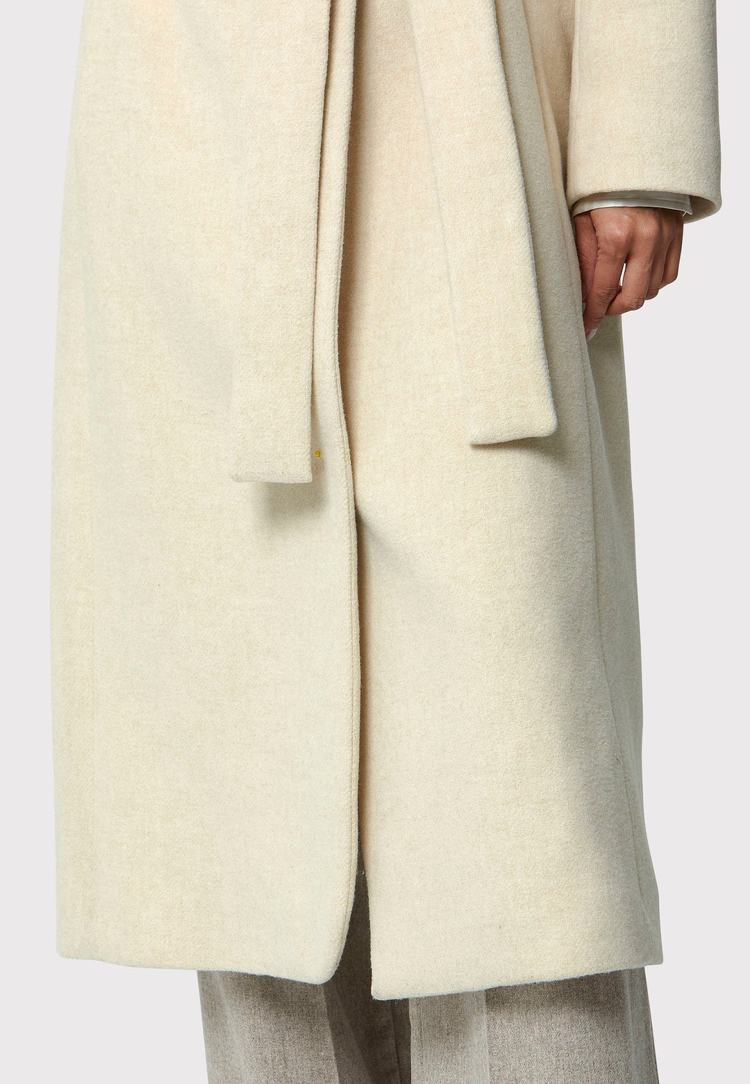 Stay warm and stylish with the Hazel Winter White Coat. Crafted from a luxurious wool blend melton, this coat features a large funnel which falls to a shawl collar and a belted waist for a flattering silhouette. Pair it with tailored trousers or a chic dress for a sophisticated winter look.