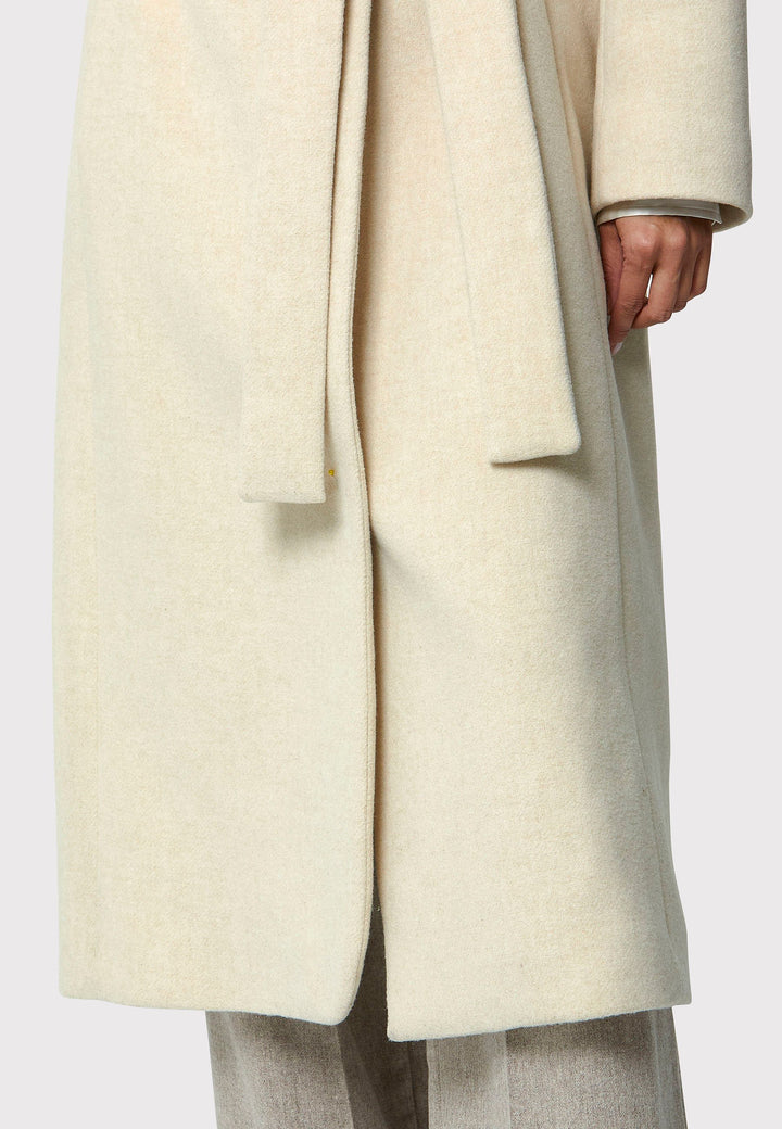 Stay warm and stylish with the Hazel Winter White Coat. Crafted from a luxurious wool blend melton, this coat features a large funnel which falls to a shawl collar and a belted waist for a flattering silhouette. Pair it with tailored trousers or a chic dress for a sophisticated winter look.