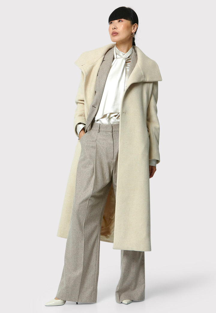 Stay warm and stylish with the Hazel Winter White Coat. Crafted from a luxurious wool blend melton, this coat features a large funnel which falls to a shawl collar and a belted waist for a flattering silhouette. Pair it with tailored trousers or a chic dress for a sophisticated winter look.