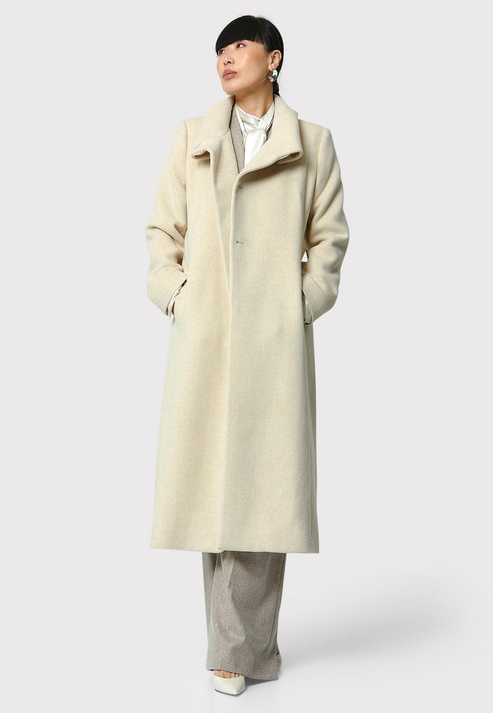 Stay warm and stylish with the Hazel Winter White Coat. Crafted from a luxurious wool blend melton, this coat features a large funnel which falls to a shawl collar and a belted waist for a flattering silhouette. Pair it with tailored trousers or a chic dress for a sophisticated winter look.