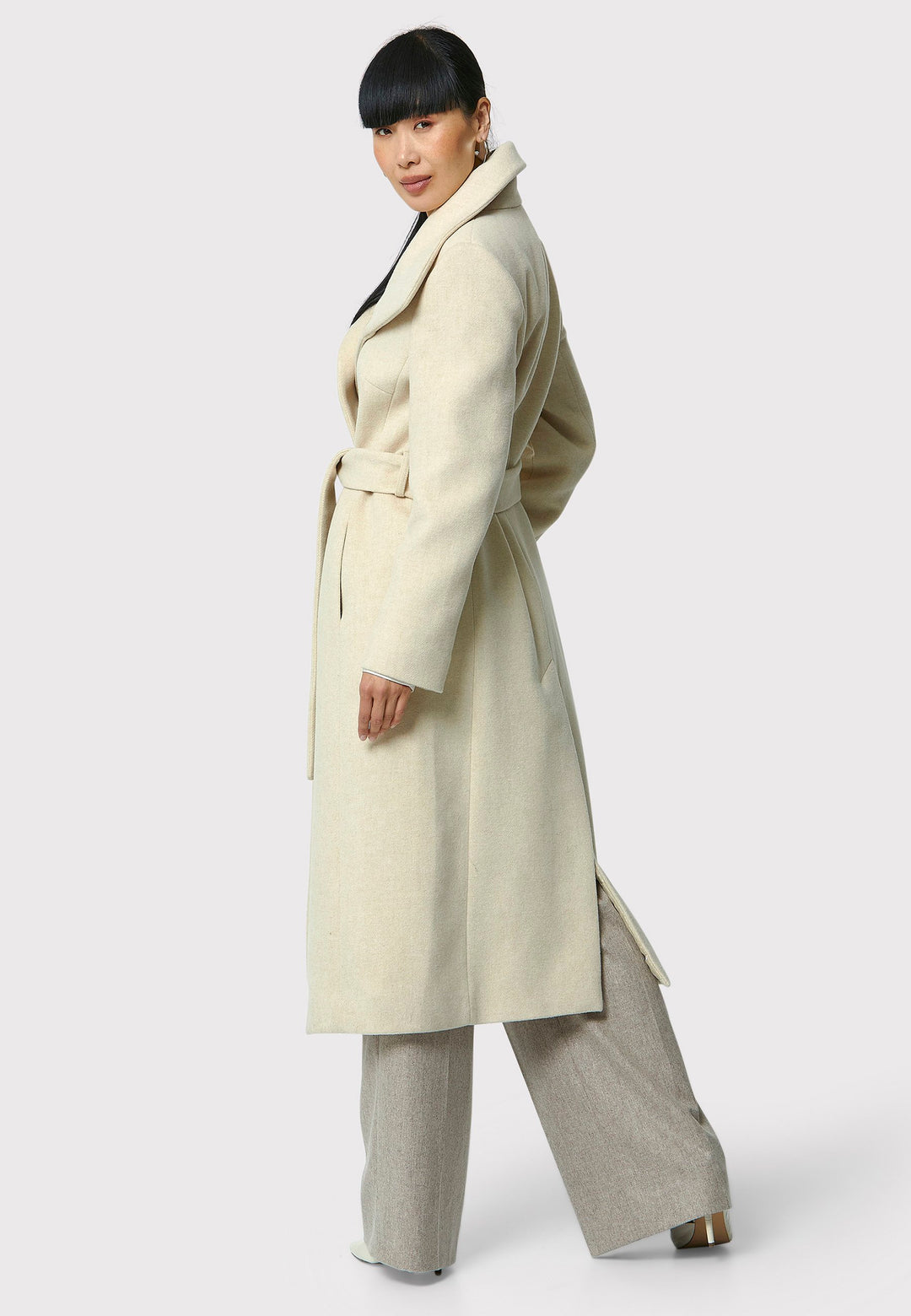 Stay warm and stylish with the Hazel Winter White Coat. Crafted from a luxurious wool blend melton, this coat features a large funnel which falls to a shawl collar and a belted waist for a flattering silhouette. Pair it with tailored trousers or a chic dress for a sophisticated winter look.