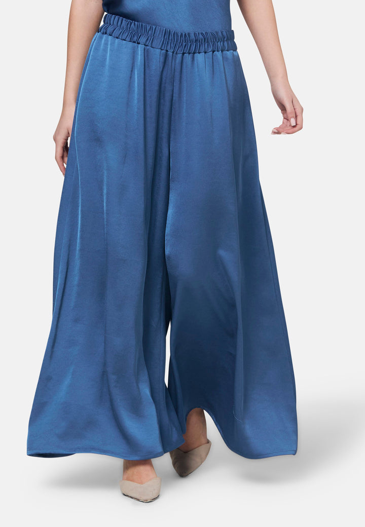 Woman wearing silk-touch satin in storm blue pants