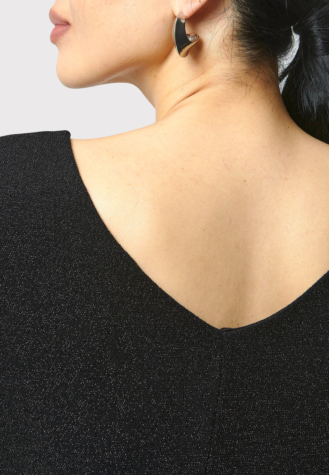 Introducing the Jamie Black Shimmer Dress, an elegant bodycon piece with full-length sleeves. Made from sparkly black jersey fabric, it features a slash neck with a slight V-back for added allure. Its midi length perfectly balances classic and modern styles. Ideal for any occasion, this dress adds a touch of glamour to your look.