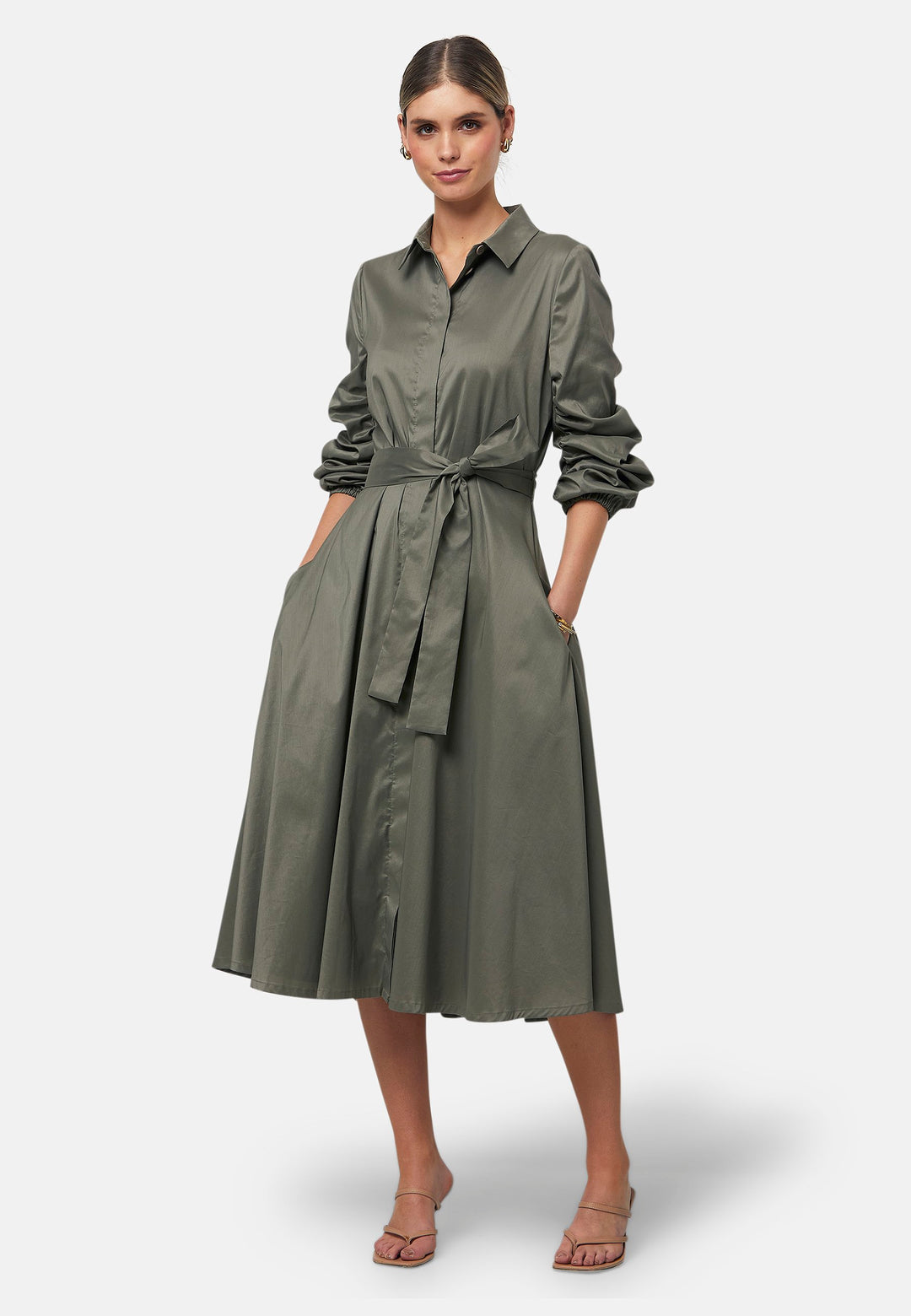 The Leah Olive midi shirt dress combines classic tailoring with a feminine touch. Featuring a button-down front and ruched three-quarter length sleeves, it offers versatility and style. The detachable tie belt cinches the waist, while the gently flared skirt provides a flattering silhouette with essential side seam pockets.