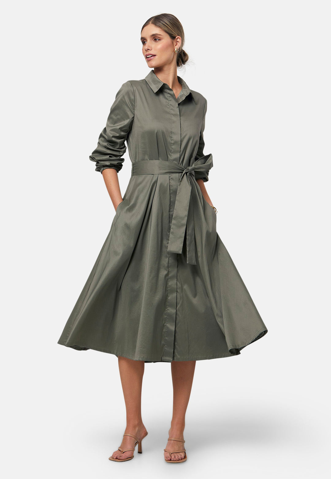 The Leah Olive midi shirt dress combines classic tailoring with a feminine touch. Featuring a button-down front and ruched three-quarter length sleeves, it offers versatility and style. The detachable tie belt cinches the waist, while the gently flared skirt provides a flattering silhouette with essential side seam pockets.