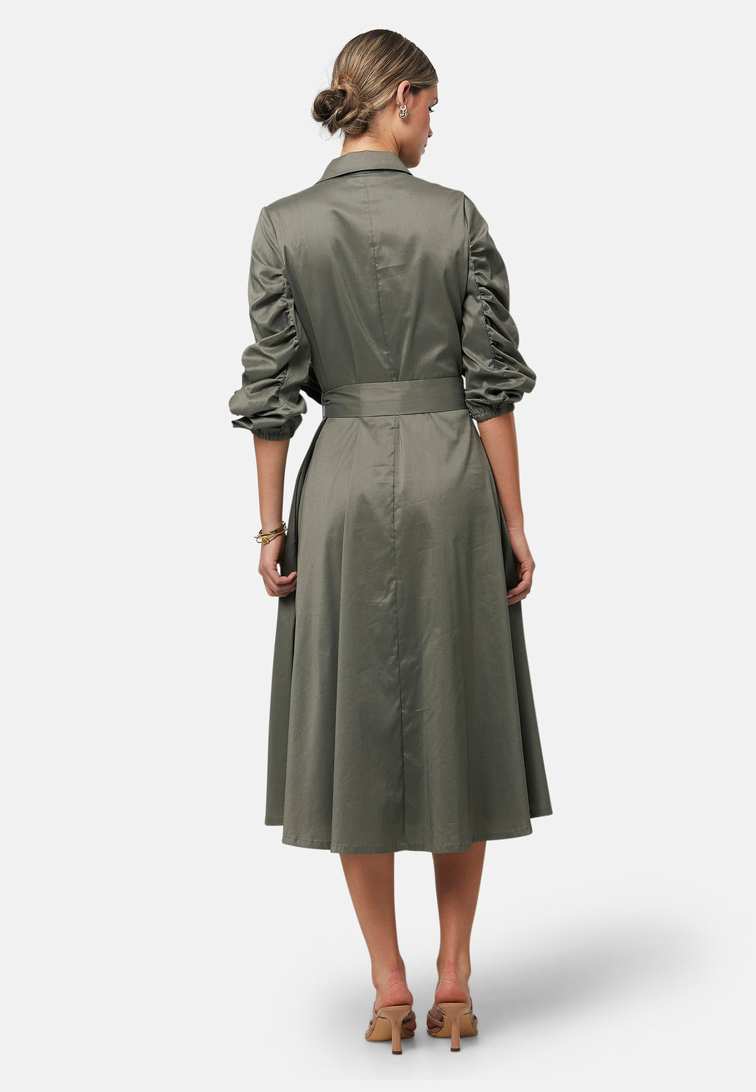 The Leah Olive midi shirt dress combines classic tailoring with a feminine touch. Featuring a button-down front and ruched three-quarter length sleeves, it offers versatility and style. The detachable tie belt cinches the waist, while the gently flared skirt provides a flattering silhouette with essential side seam pockets.