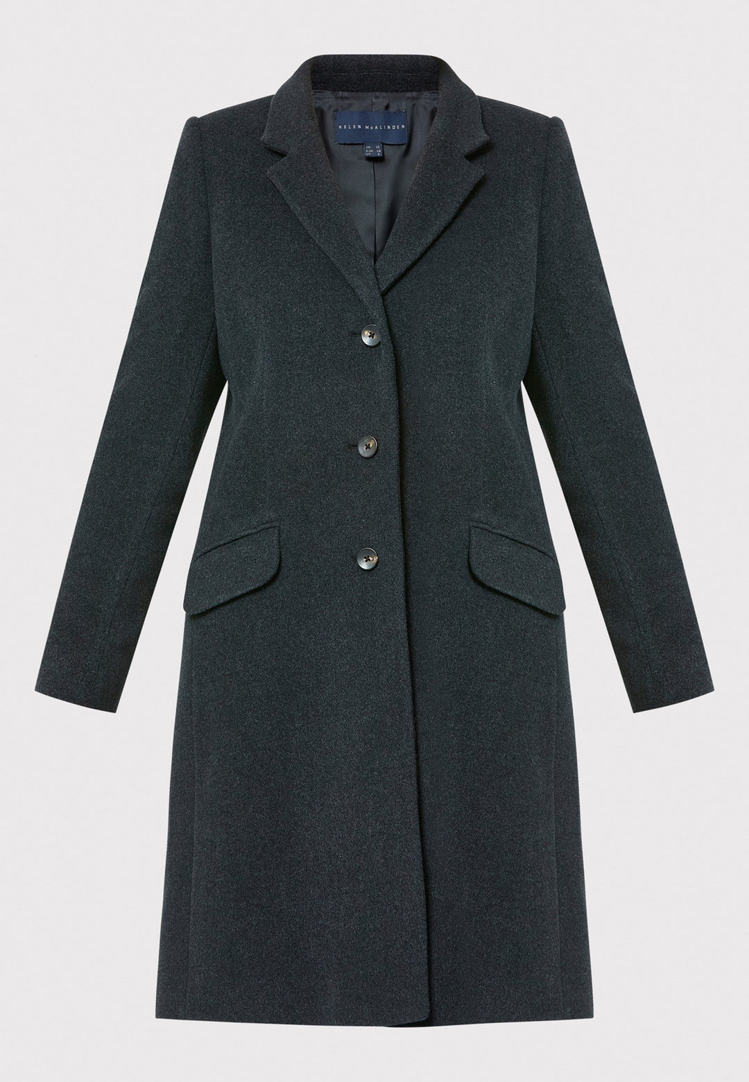 The Leighton charcoal grey coat is crafted from a luxurious wool and cashmere melton blend. Expertly crafted, this knee-length coat offers both warmth and sophistication. Drawing inspiration from refined men's tailoring, it showcases a tidy collar and revere design. With a three-button finish and practical pockets, this coat effortlessly combines functionality with style. Elevate your outerwear collection with this versatile and classic piece that will ensure you stay chic and cozy throughout the winter sea