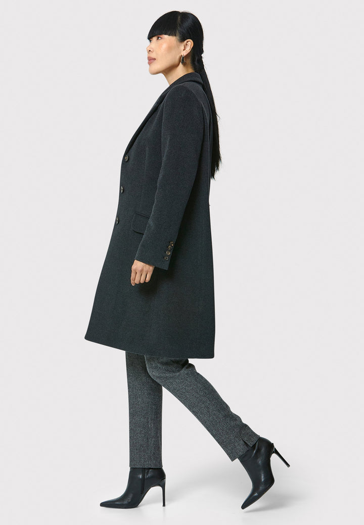 The Leighton charcoal grey coat is crafted from a luxurious wool and cashmere melton blend. Expertly crafted, this knee-length coat offers both warmth and sophistication. Drawing inspiration from refined men's tailoring, it showcases a tidy collar and revere design. With a three-button finish and practical pockets, this coat effortlessly combines functionality with style. Elevate your outerwear collection with this versatile and classic piece that will ensure you stay chic and cozy throughout the winter sea