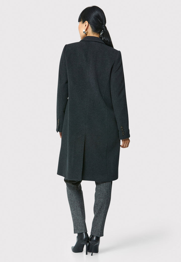 The Leighton charcoal grey coat is crafted from a luxurious wool and cashmere melton blend. Expertly crafted, this knee-length coat offers both warmth and sophistication. Drawing inspiration from refined men's tailoring, it showcases a tidy collar and revere design. With a three-button finish and practical pockets, this coat effortlessly combines functionality with style. Elevate your outerwear collection with this versatile and classic piece that will ensure you stay chic and cozy throughout the winter sea