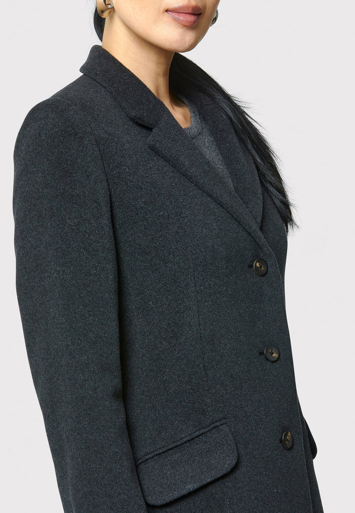 The Leighton charcoal grey coat is crafted from a luxurious wool and cashmere melton blend. Expertly crafted, this knee-length coat offers both warmth and sophistication. Drawing inspiration from refined men's tailoring, it showcases a tidy collar and revere design. With a three-button finish and practical pockets, this coat effortlessly combines functionality with style. Elevate your outerwear collection with this versatile and classic piece that will ensure you stay chic and cozy throughout the winter sea