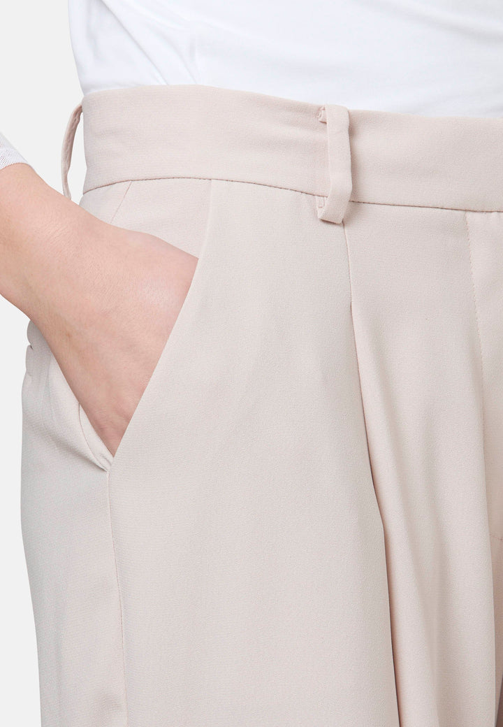 Woman wearing natural pearl pants