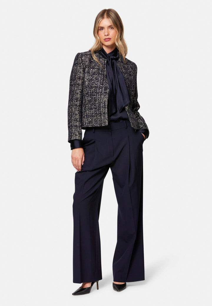 Lyra, the modern wide-leg trouser. Tailored with a natural waist, soft front pleats and sharp pressed creases. Full-length and fluid for an elongating line, with side pockets, belt loops and neat back welt pockets. Wear with the Darcie blazer for the coordinating suit, or dress down with a simple knit.