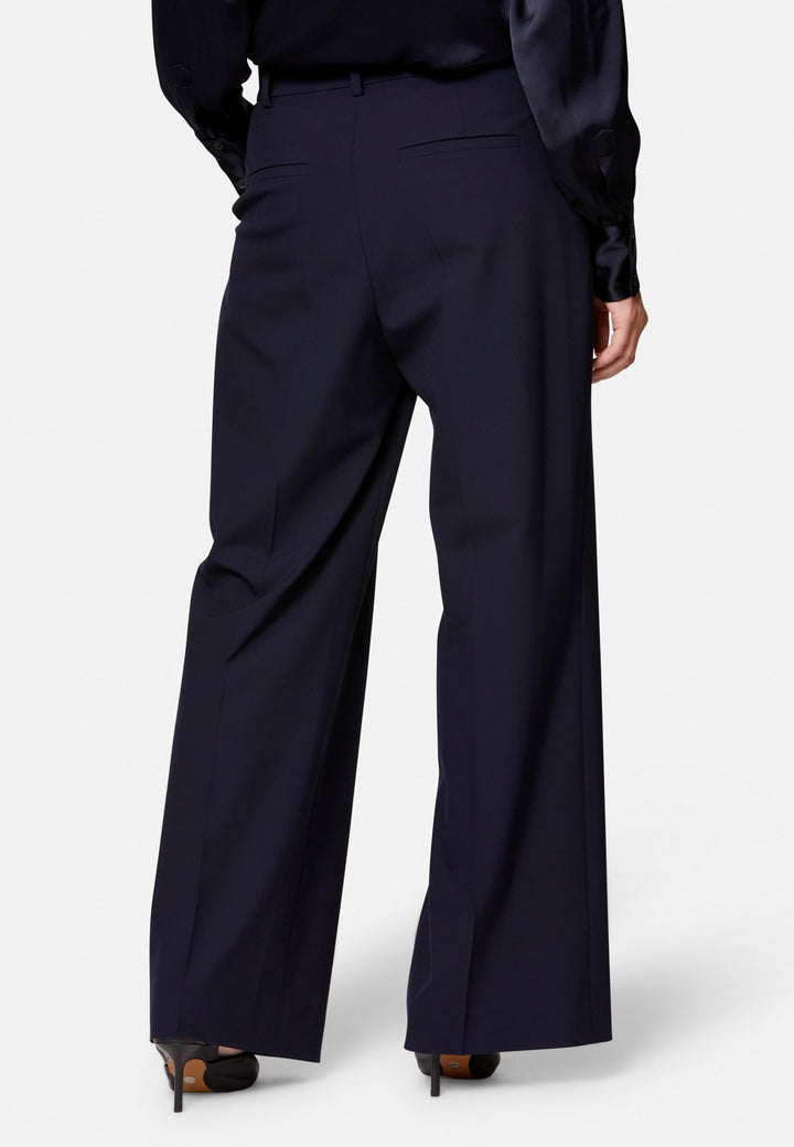 Lyra, the modern wide-leg trouser. Tailored with a natural waist, soft front pleats and sharp pressed creases. Full-length and fluid for an elongating line, with side pockets, belt loops and neat back welt pockets. Wear with the Darcie blazer for the coordinating suit, or dress down with a simple knit.