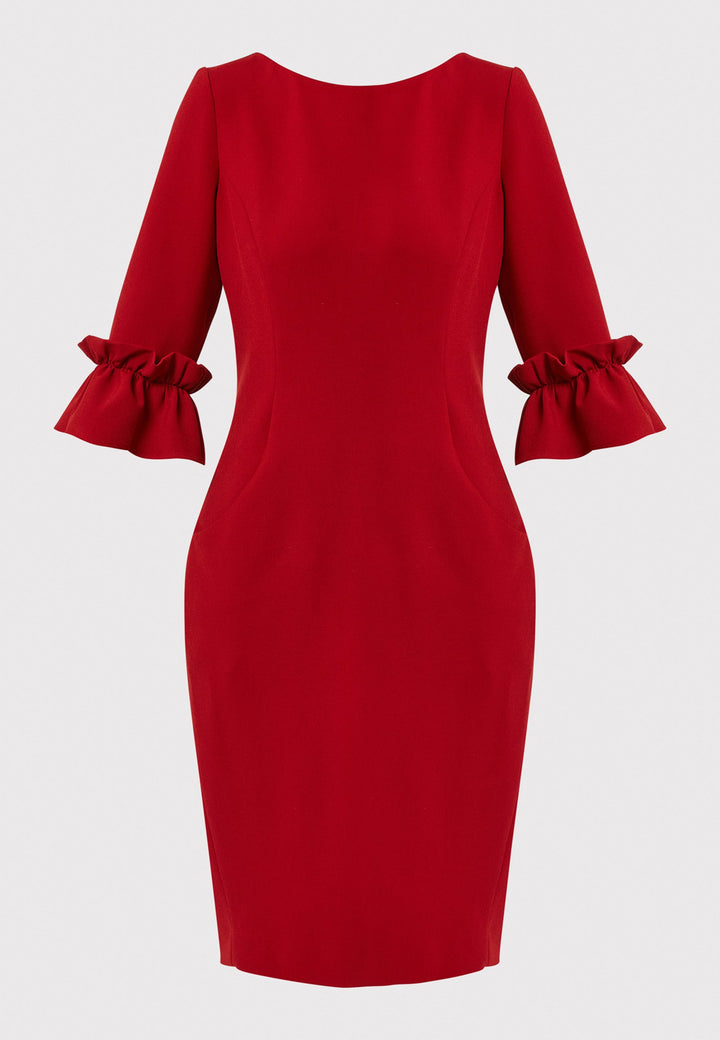 The Maisie Garnet Red Dress, impeccably tailored from signature tricotine fabric with a hint of stretch. This body-skimming silhouette features a round neck and bracelet-length sleeves complemented by exaggerated frill cuffs, ideal for evening cocktails, a night at the theatre, or a stylish winter wedding.