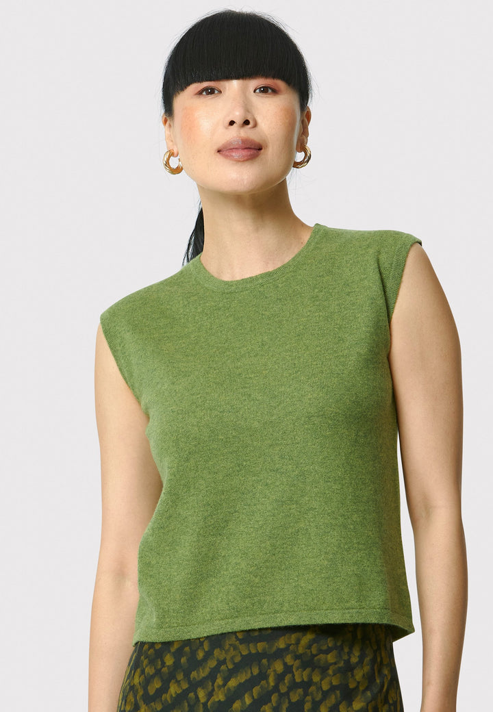 The Marlena Chartreuse Green Cashmere Sweater-Vest is a sleeveless, round-neck top that offers versatile styling options. Wear it as a simple underpinning for the matching Greta cardigan to complete a coordinated look. Alternatively, layer it as a sweater vest over your favorite crisp white shirts for a stylish and contemporary outfit. Made from luxurious cashmere, the Marlena Sweater-Vest adds an extra layer of comfort and sophistication to your wardrobe.