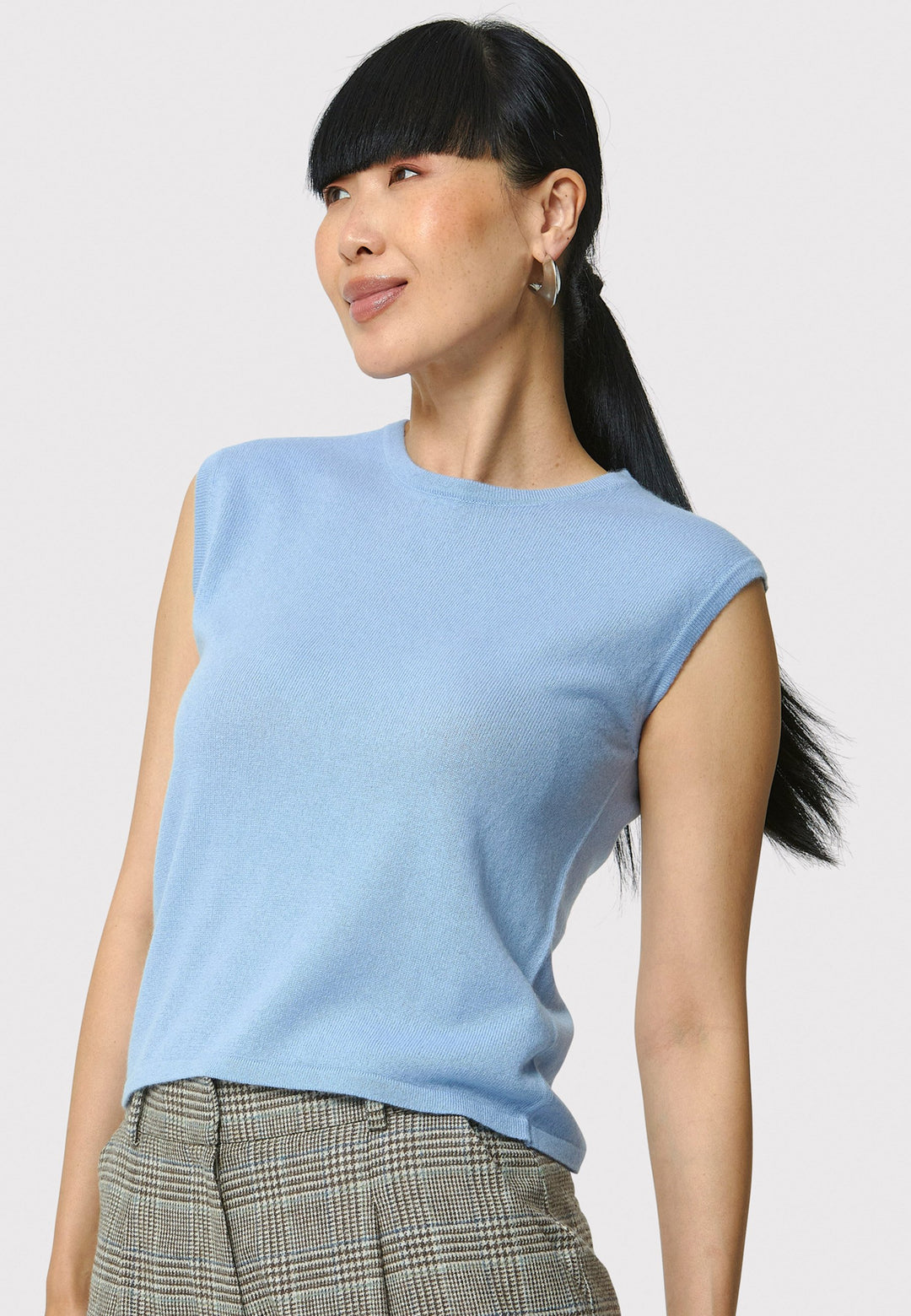 The Marlena Porcelain Blue Cashmere Sweater-Vest is a sleeveless, round-neck top that offers versatile styling options. Wear it as a simple underpinning for the matching Greta cardigan to complete a coordinated look. Alternatively, layer it as a sweater vest over your favorite crisp white shirts for a stylish and contemporary outfit. Made from luxurious cashmere, the Marlena Sweater-Vest adds an extra layer of comfort and sophistication to your wardrobe.