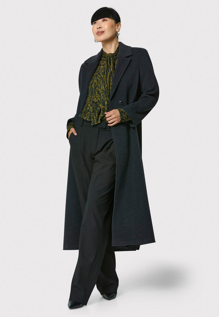 The Mikaela Charcoal Grey Coat, crafted from a luxurious blend of wool and cashmere, offers both style and versatility. This long duster coat features a classic collar and revere, button closure and practical side seam slits. Wear it straight for a relaxed silhouette, or cinch the waist with the matching self-fabric belt for a more defined shape. Complete with side seam pockets, this coat is a refined addition to your outerwear collection.