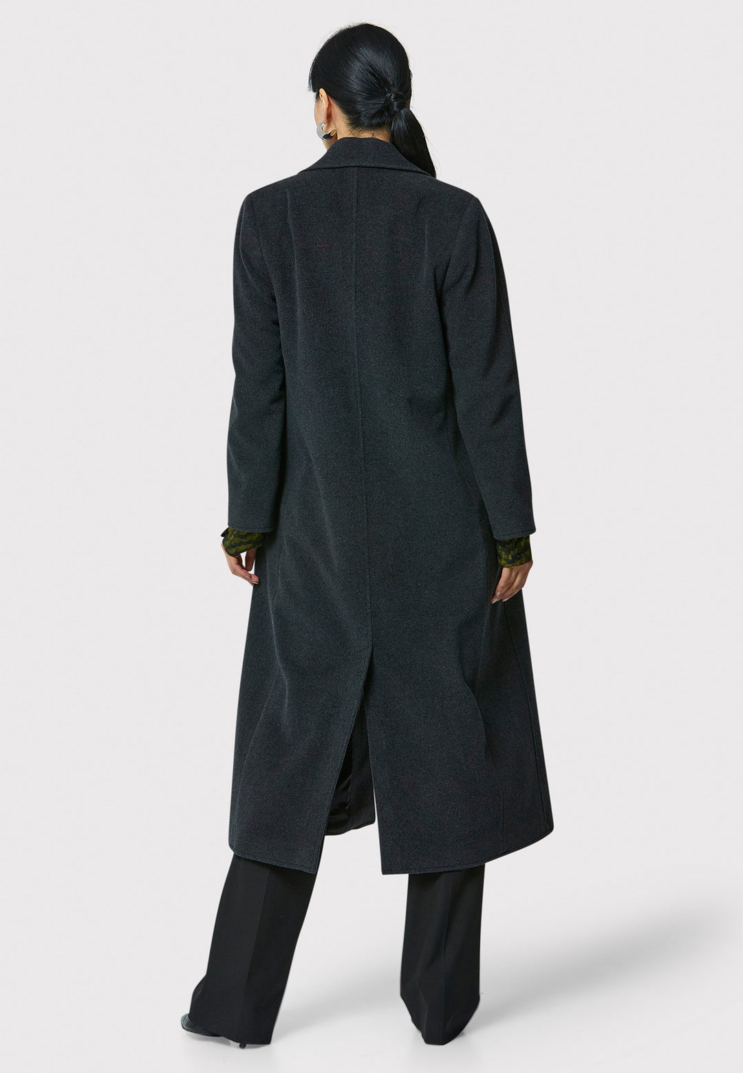 The Mikaela Charcoal Grey Coat, crafted from a luxurious blend of wool and cashmere, offers both style and versatility. This long duster coat features a classic collar and revere, button closure and practical side seam slits. Wear it straight for a relaxed silhouette, or cinch the waist with the matching self-fabric belt for a more defined shape. Complete with side seam pockets, this coat is a refined addition to your outerwear collection.