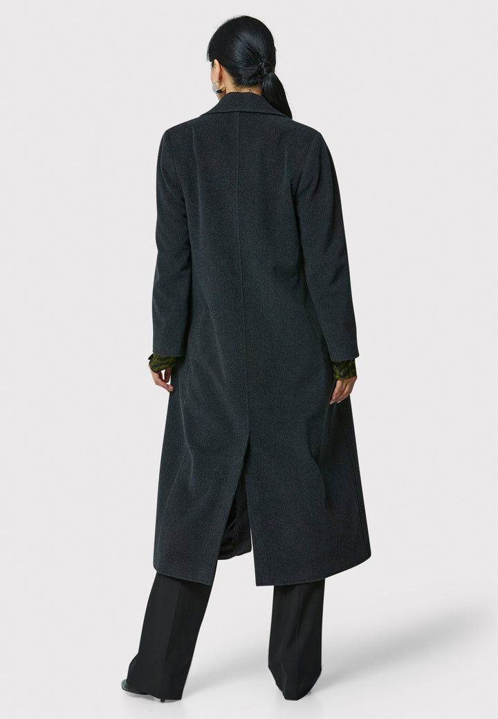 The Mikaela Charcoal Grey Coat, crafted from a luxurious blend of wool and cashmere, offers both style and versatility. This long duster coat features a classic collar and revere, button closure and practical side seam slits. Wear it straight for a relaxed silhouette, or cinch the waist with the matching self-fabric belt for a more defined shape. Complete with side seam pockets, this coat is a refined addition to your outerwear collection.
