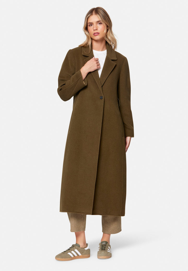 woman wearing umber brown long wool coat