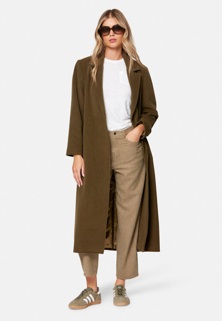woman wearing umber brown long wool coat