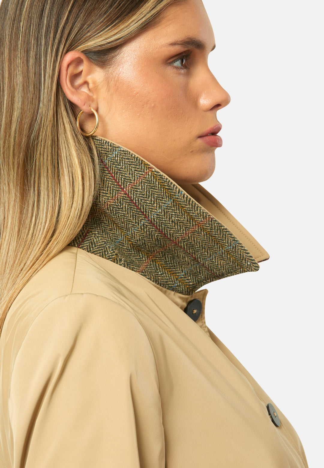 woman wearing beige mac trench with undercollar wollen check