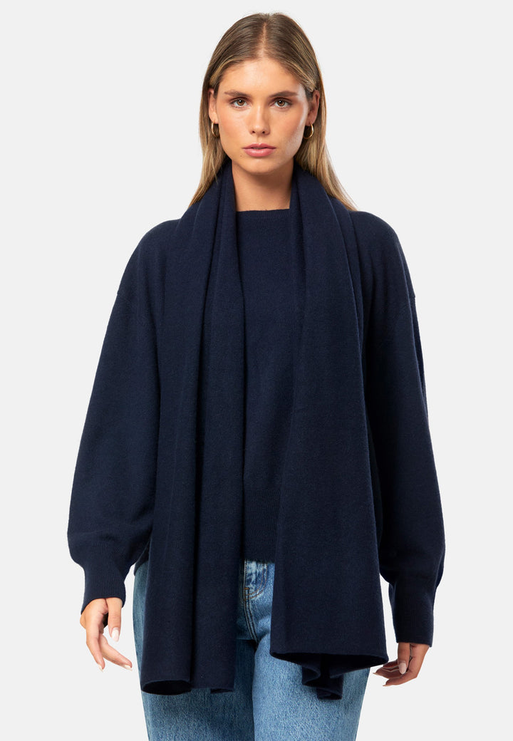 Knitted in pure cashmere with a soft handle, this generously cut wrap drapes fluidly. Loop, wrap or wear as a shoulder cover-up. An effortless layer for denim days and casual outings. In timeless navy, it works layered over tailoring or styled with coordinating knitwear.