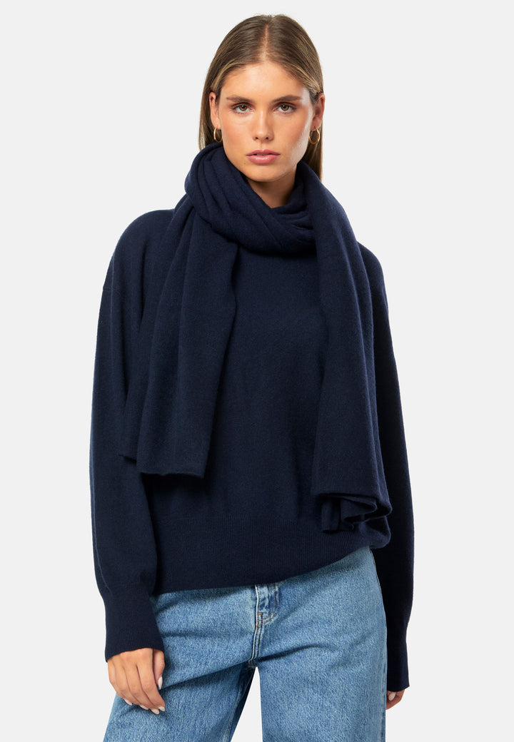 Knitted in pure cashmere with a soft handle, this generously cut wrap drapes fluidly. Loop, wrap or wear as a shoulder cover-up. An effortless layer for denim days and casual outings. In timeless navy, it works layered over tailoring or styled with coordinating knitwear.