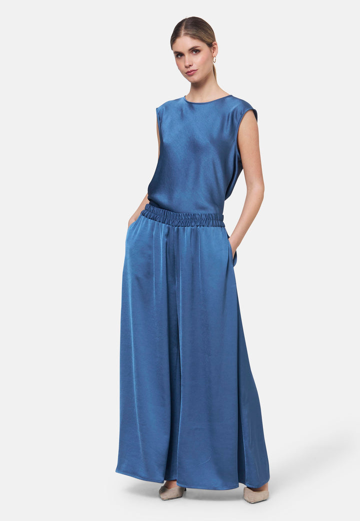 Woman wearing silk-touch satin in storm blue top